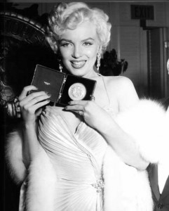 Marilyn receives a Photoplay award in recognition of her performances in 'Gentlemen Prefer Blondes' and 'How to Marry a Millionaire', 1954.