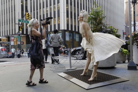 Documentary filmmaker Kathy Brew does a video of a Marilyn Monroe sculpture, while making a film about artist Seward Johnson, whose 18 sculptures have been placed in the pedestrian islands on Broadway in the city's garment district.
